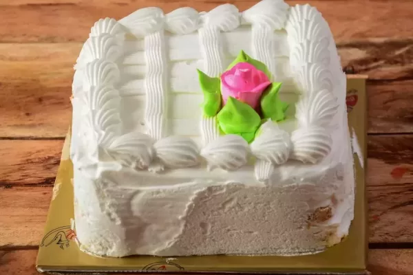 Freshly made rasmalai cream cake on wooden table. selective focus