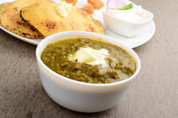 Closeup of sarson ka saag with white makhan on the table, healthy indian food