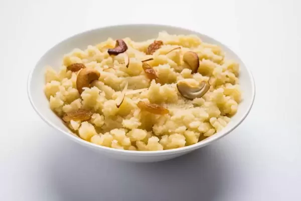 Plain Semolina/Suji Halwa also known as Sweet Rava Sheera OR Shira - Indian festival sweet garnished with dry fruits. Served in a plate or Bowl, selective focus